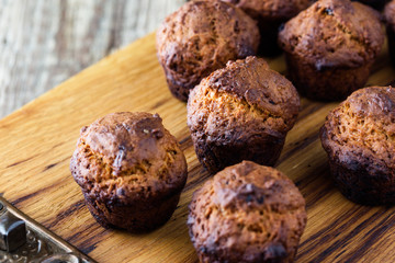 Burnt muffins on rustic wooden table