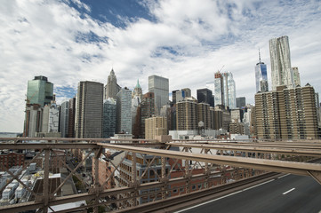 Fototapeta na wymiar Manhattan skyline seen from the beautiful Brooklyn bridge. Cloudy day in New York City, USA.