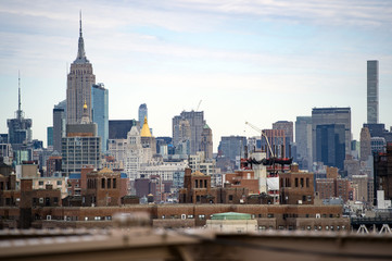 Obraz premium Manhattan skyline seen from the beautiful Brooklyn bridge. Cloudy day in New York City, USA.