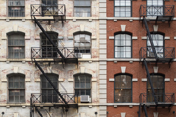 Close-up view of New York City style apartment buildings with emergency stairs along Mott Street in the Chinatown neighborhood of Manhattan NYC.