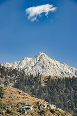 Fototapeta na wymiar A distant view of Dhauladhar Mountain ranges during a sunny day. Triund, Dharamshala, Himachal Pradesh. India