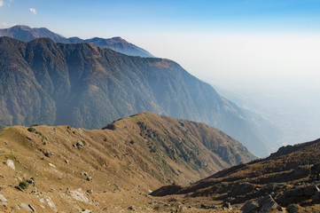 A beautiful view of Dhauladhar Mountain ranges during a sunny day and some clouds. Triund, Himachal Pradesh. India