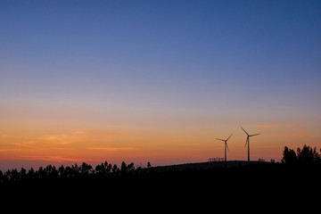 Fototapeta na wymiar sunset over some wind turbine generator