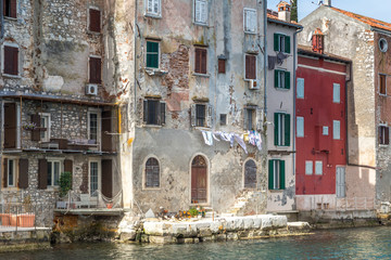 Historic buildings on the coast of Rovinj town on Adriatic sea, one of major tourist attractions at Istria in Croatia, Europe.