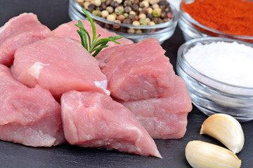 Raw fresh pork with spices on slate