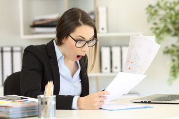 Amazed executive checking sales results at office