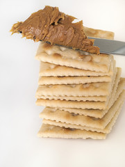 Stack of crackers and peanut butter