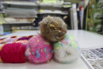 Colorful wool knittings on the table in store