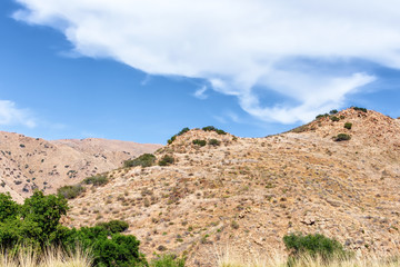 Dry California hilltops on hiking trail on hot spring day
