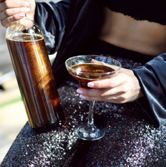 Beautiful fashion woman drink gold glitter martini cosmopolitan cocktail 