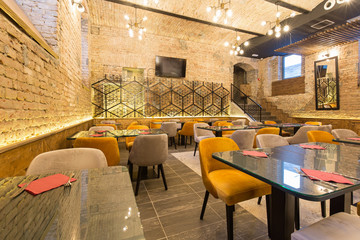 Interior of a modern hotel restaurant with brick wall