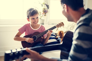 Young boy playing guitar - Powered by Adobe