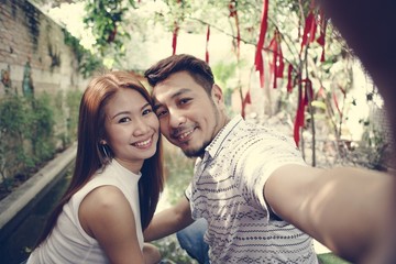 Fototapeta na wymiar Happy couple taking selfie together
