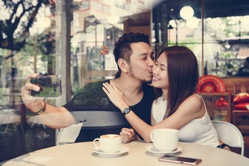 Lovely asian couple having coffee