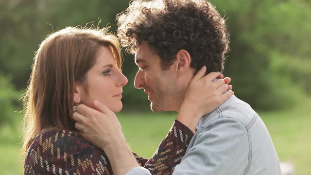 portrait of young couple kissing in a park,summer time