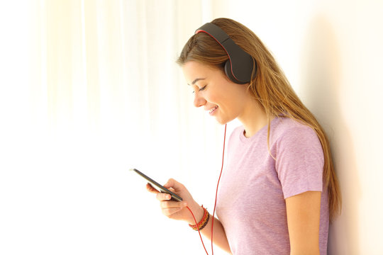 Teenager listening to music on line using a phone