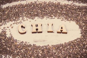 Vintage photo, Inscription chia and heap of seeds, concept of food containing natural vitamins, fiber and minerals