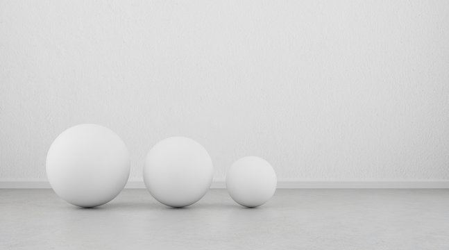 Abstract of white geometric sphere balls are on clean concrete floor and wall background.3d rendering © nuchao
