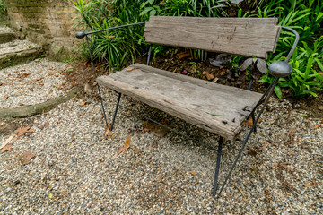 Wood bench on gravel floor