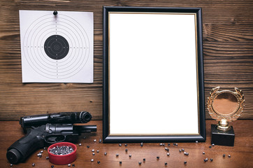 Best shooter diploma. First place winner in shooting. Professional shooter certificate mock up. Gun, gold medal and blank photo frame.