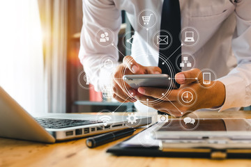 close up of hand using tablet ,laptop, and holding smartphone online banking payment communication network,internet wireless application development sync app,virtual graphic  icon diagram 
