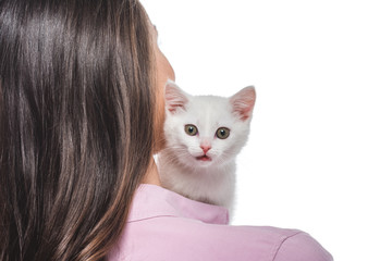 rear view of young woman with kitten on shoulder isolated on white background