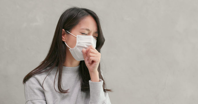 Woman wearing mask and feeling sick