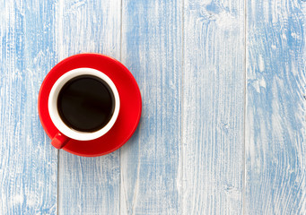 Red cup coffee on blue wooden table, Top view with copy space