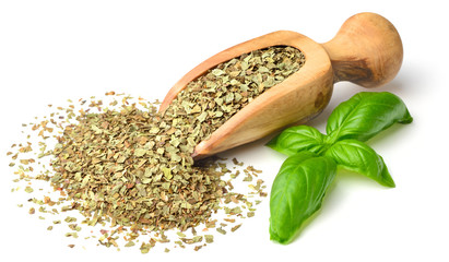 dried herb, basil leaves in the wooden scoop, isolated on white