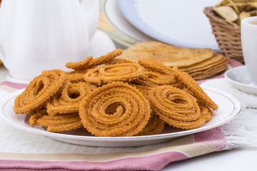 Indian Traditional Snack Chakli, a spiral shaped crisp deep fried snack, It is known as  Chakali, Murukku, Muruku, Murkoo, Chakri in Gujarat, Chakli in Maharashtra and Northern India