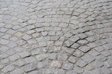 Old cobblestones laid in a circular pattern