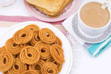 Indian Traditional Snack Chakli, a spiral shaped crisp deep fried snack, It is known as  Chakali, Murukku, Muruku, Murkoo, Chakri in Gujarat, Chakli in Maharashtra and Northern India