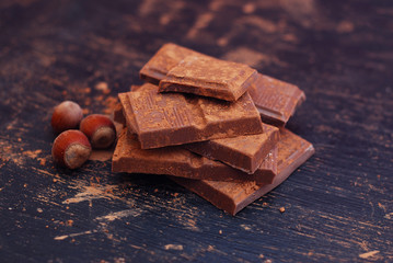 Broken Chocolate Pieces and Cocoa Powder on Black background. Dessert Recipie Ingredinets. Food Preparation