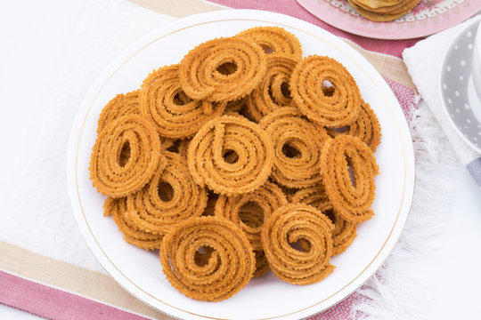 Indian Traditional Snack Chakli, a spiral shaped crisp deep fried snack, It is known as  Chakali, Murukku, Muruku, Murkoo, Chakri in Gujarat, Chakli in Maharashtra and Northern India