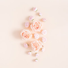 Flowers composition. Pattern made of beige rose flowers on pastel yellow background. Flat lay, top view, square