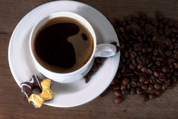 Coffee cup and beans on old kitchen table. Top view with copyspa