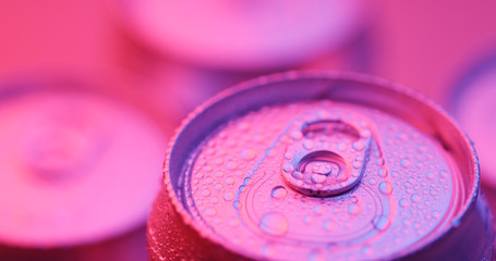 Beer can with water droplet with purple light