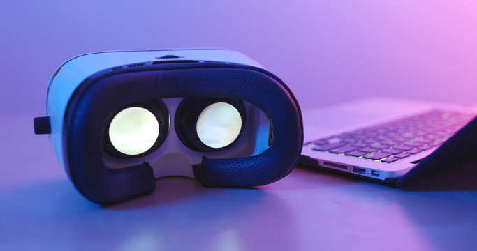 VR device with laptop under purple and blue light