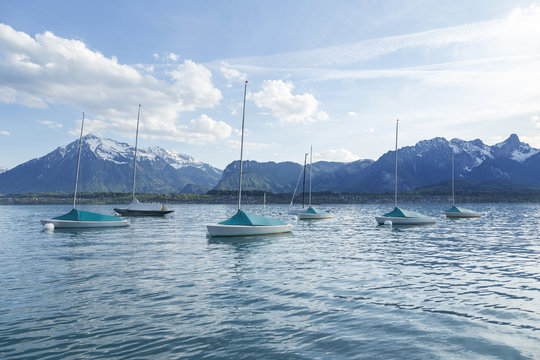 Sailing boats in port at lake Thun infornt of Alps mountain