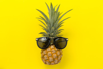 Summer Holidays background Concept, pineapple with glasses On a yellow background top view