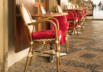 Colorful cozy street with tables of cafe at a sunny morning