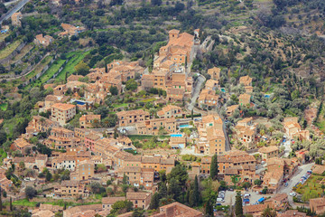 Fototapeta na wymiar Deia town in Majorca island. Birds eye view of one of the prettiest villages on the northwest coast in Serra de Tramuntana mountains.