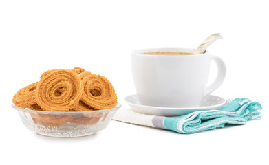 Indian Traditional Snack Chakli with Tea, a spiral shaped crisp deep fried snack, It is known as  Chakali, Murukku, Muruku, Murkoo, Chakri in Gujarat, Chakli in Maharashtra and Northern India