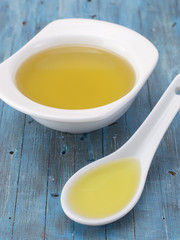 olive oil on a blue wooden background. 