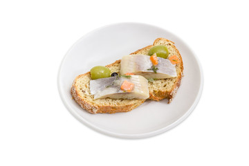 Open sandwich with pickled herring, olives and brown sprouted bread