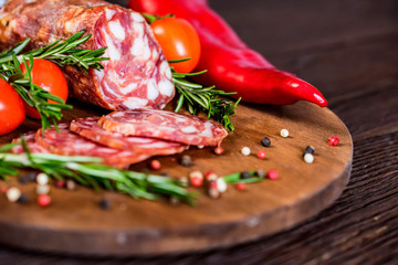 Tasty salami with tomatoes and peppercorn close