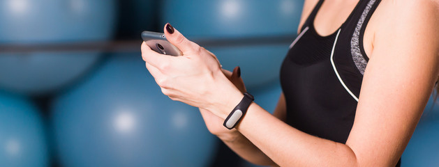 Female hand with fitness tracker at the gym close up