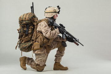 Soldier in camouflage holding rifle