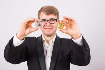 Fototapeta na wymiar Golden Bitcoin in a man hand, Digital symbol of a virtual cryptocurrency.