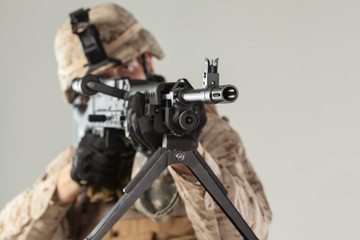 Soldier in camouflage holding rifle